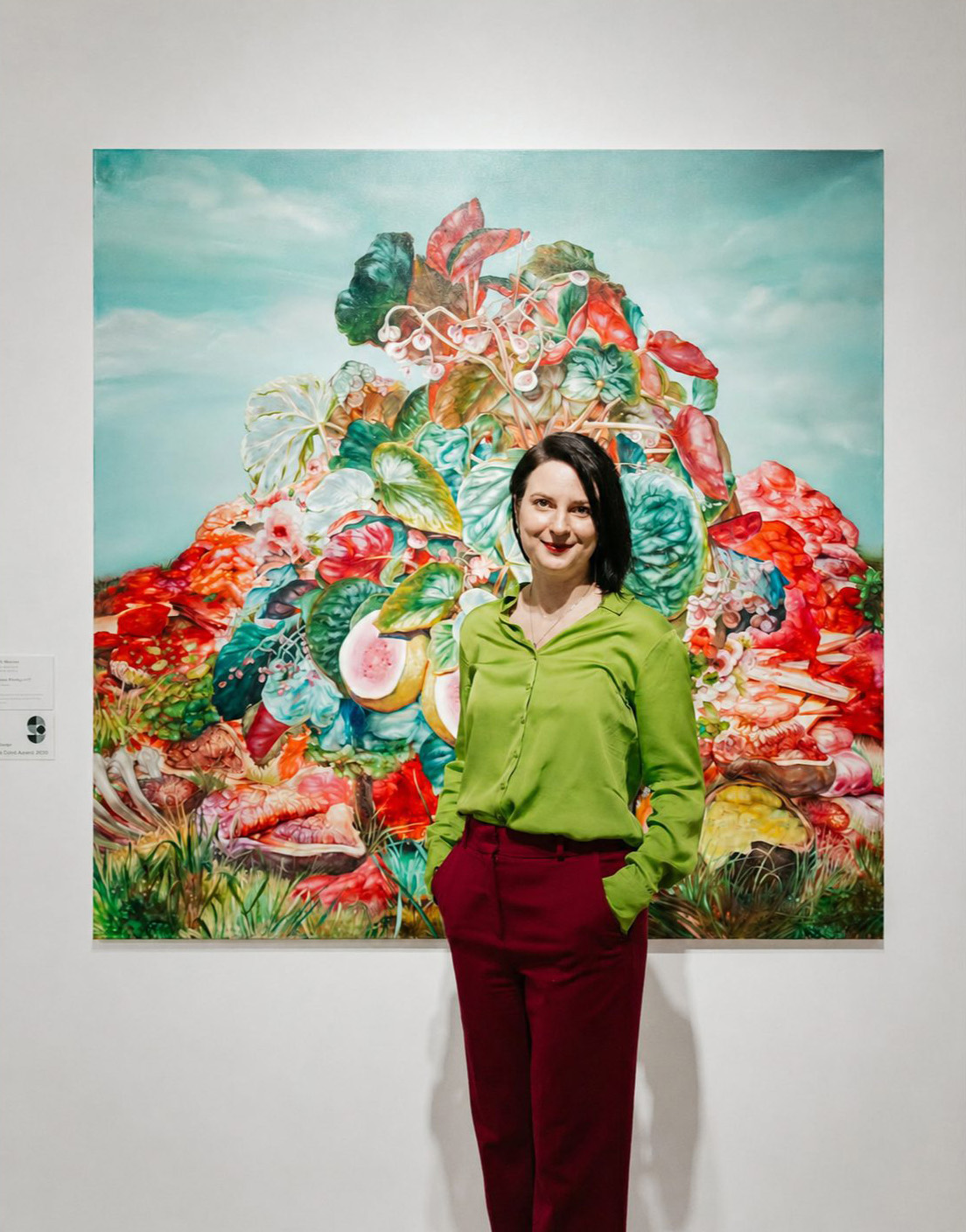 Karla Marchesi standing in front of her painting 'Wasted Waiting'
